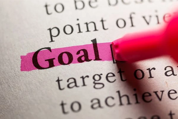 The word "Goal" is highlighted in pink on a printed page with a pink highlighter.